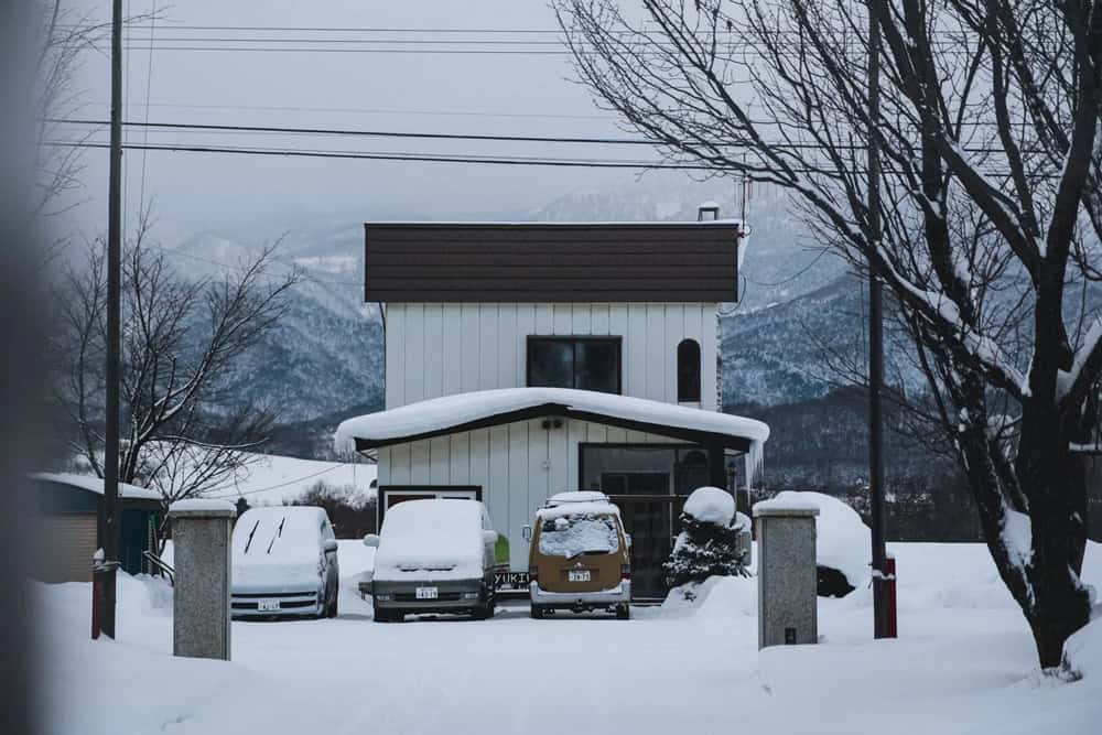 Yukiumi Hokkaido lodge in Nunobe, Furano, with vans under heavy snow