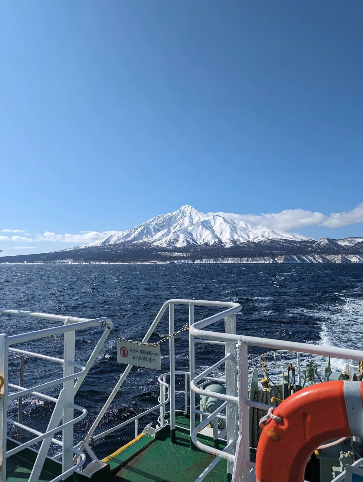 Snow-covered Mount Rishiri seen from the Wakkanai ferry on a clear spring day