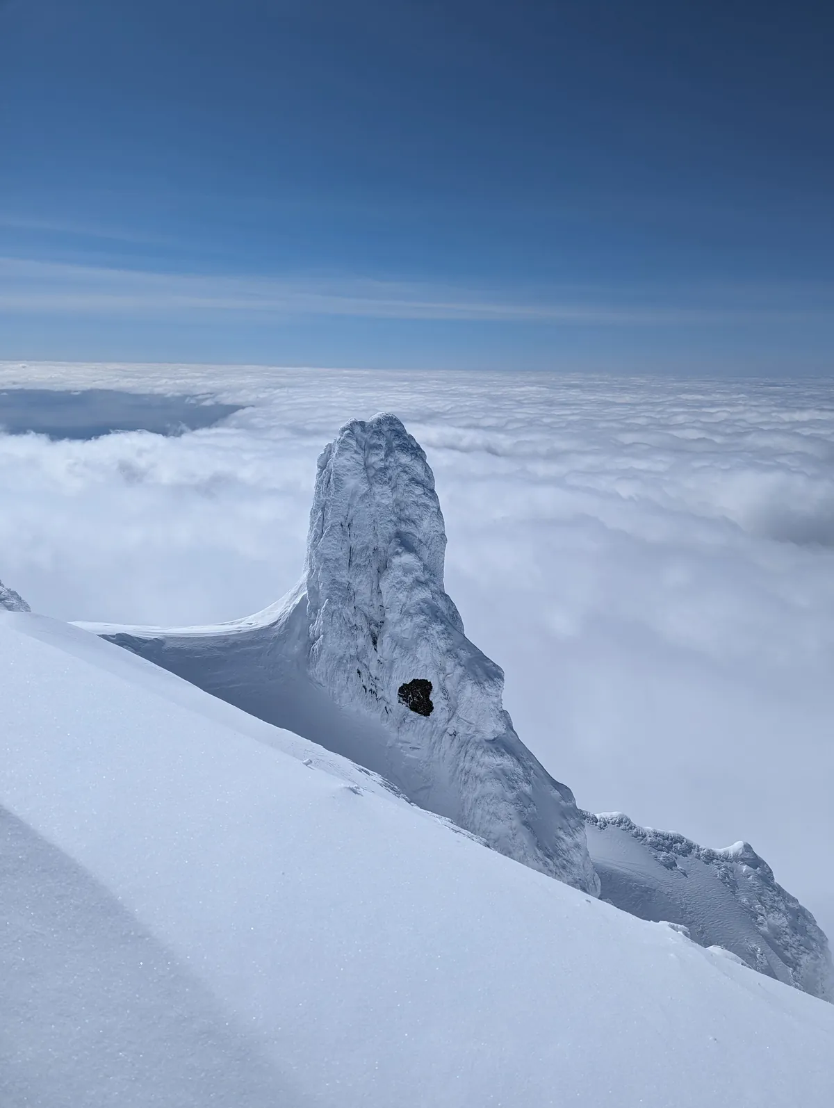 Rime-covered rock pinnacle near the summit of Mount Rishiri above the clouds