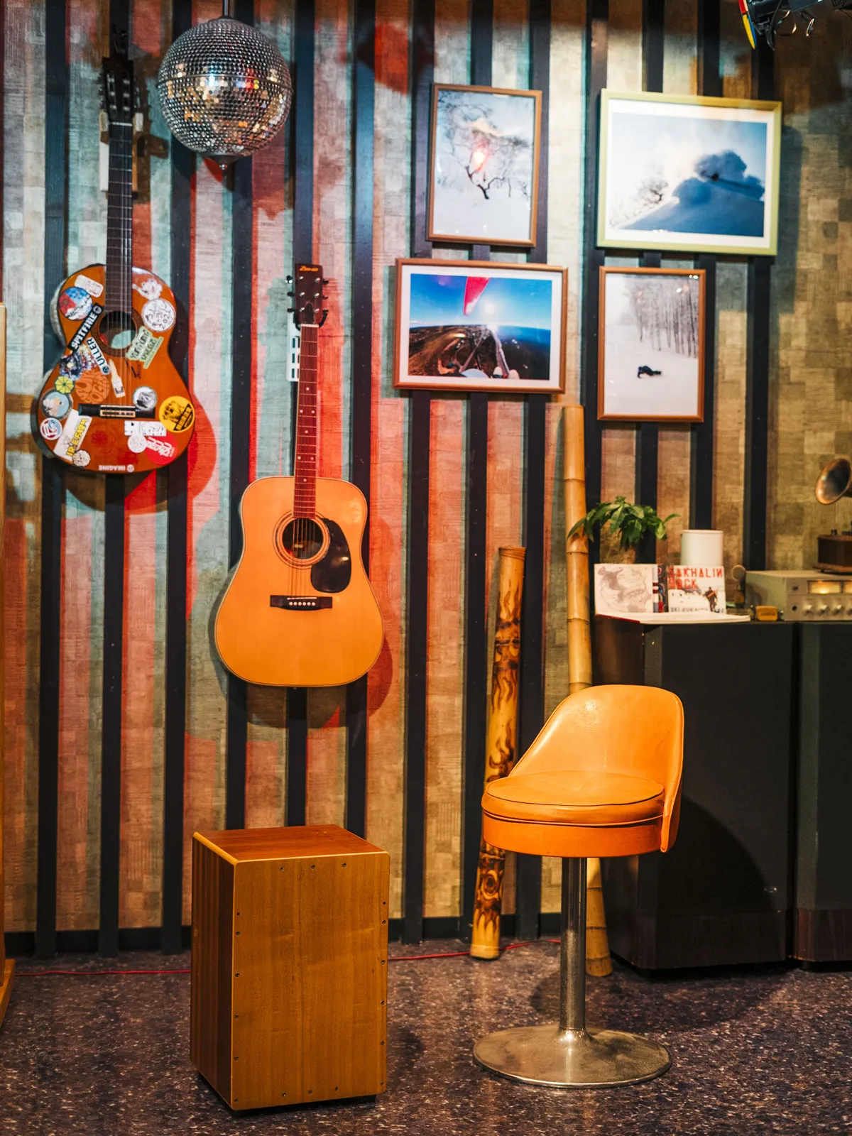 Guitars, ski photos and bar stools in the Tokachi Base Club lounge